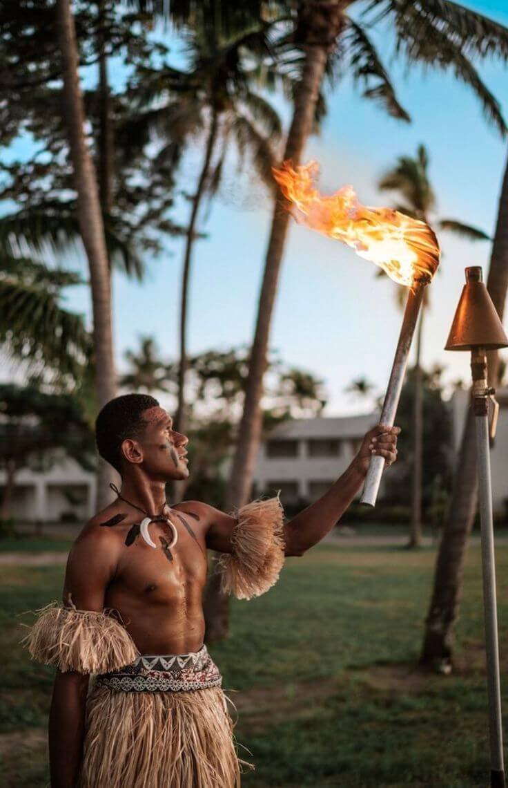 Fijian fire performer in traditional dress