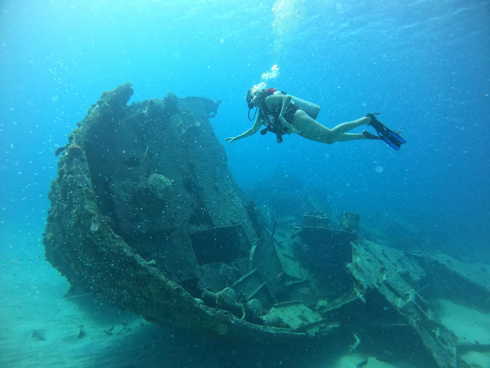 Scuba diver exploring a shipwreck underwater